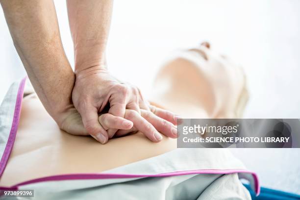 first-aider practising chest compressions - aider stock pictures, royalty-free photos & images
