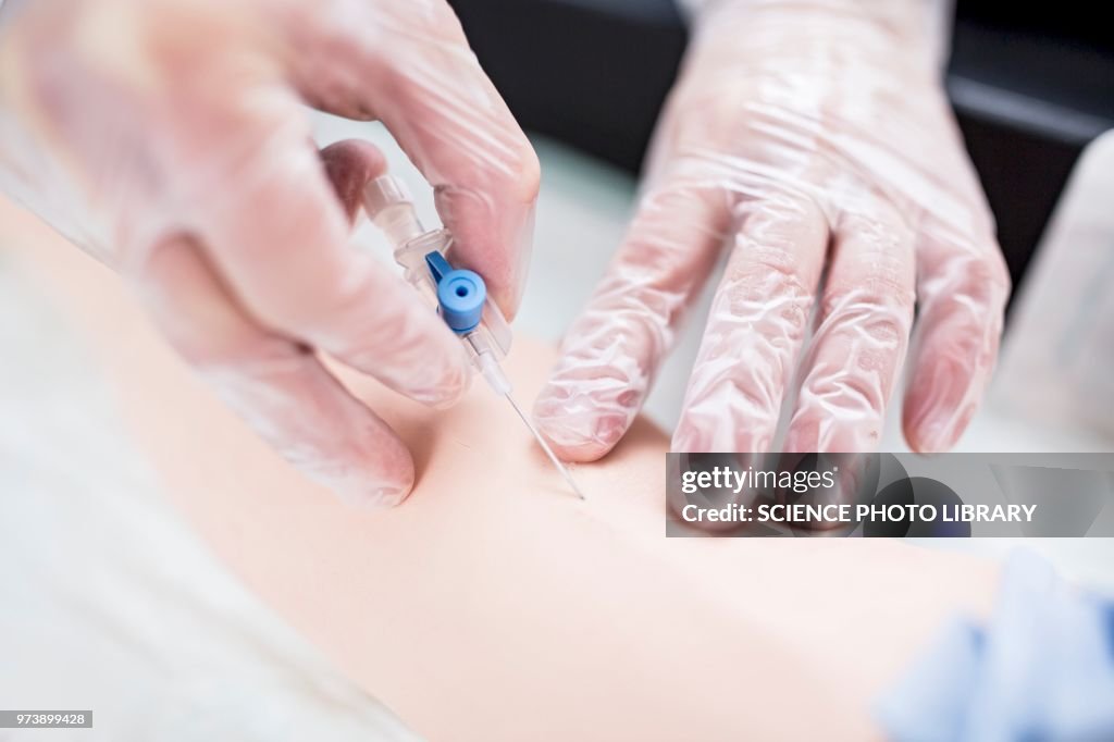 Doctor practising inserting an IV line