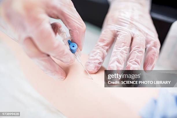 doctor practising inserting an iv line - inserting stock pictures, royalty-free photos & images