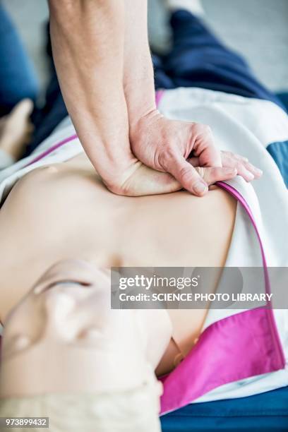 first-aider practising chest compressions - aider stock pictures, royalty-free photos & images