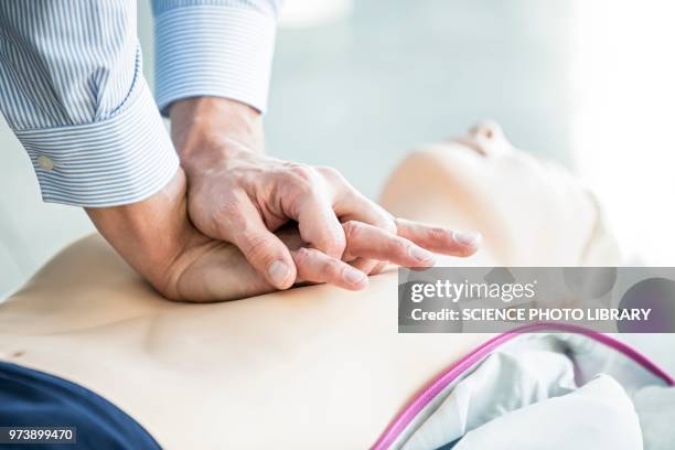 first-aider practising chest compressions - first aid training stock pictures, royalty-free photos & images