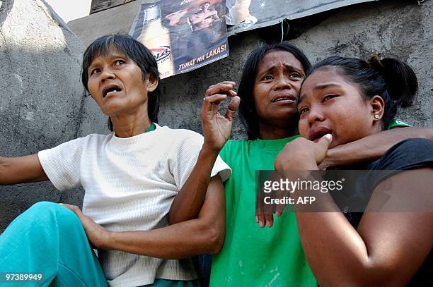 Residents of a shanty area cry during a demolition operation in the Manila suburb of Navotas on March 2, 2010. Clashes broke out between demolition...