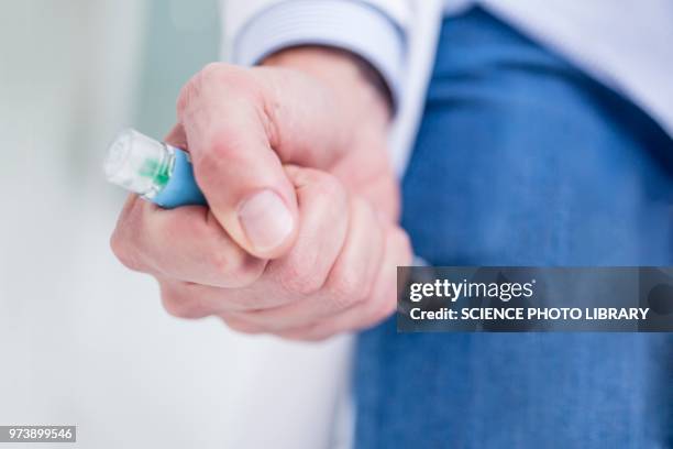 woman injecting herself in the thigh - injecting pen stock pictures, royalty-free photos & images