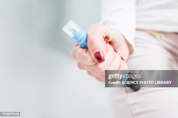 woman injecting herself in the thigh - adrenaline injection stock pictures, royalty-free photos & images