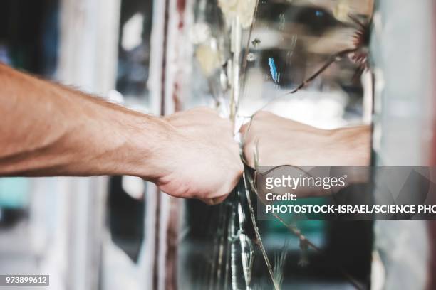 aggravated man punches a mirror - punching stock pictures, royalty-free photos & images