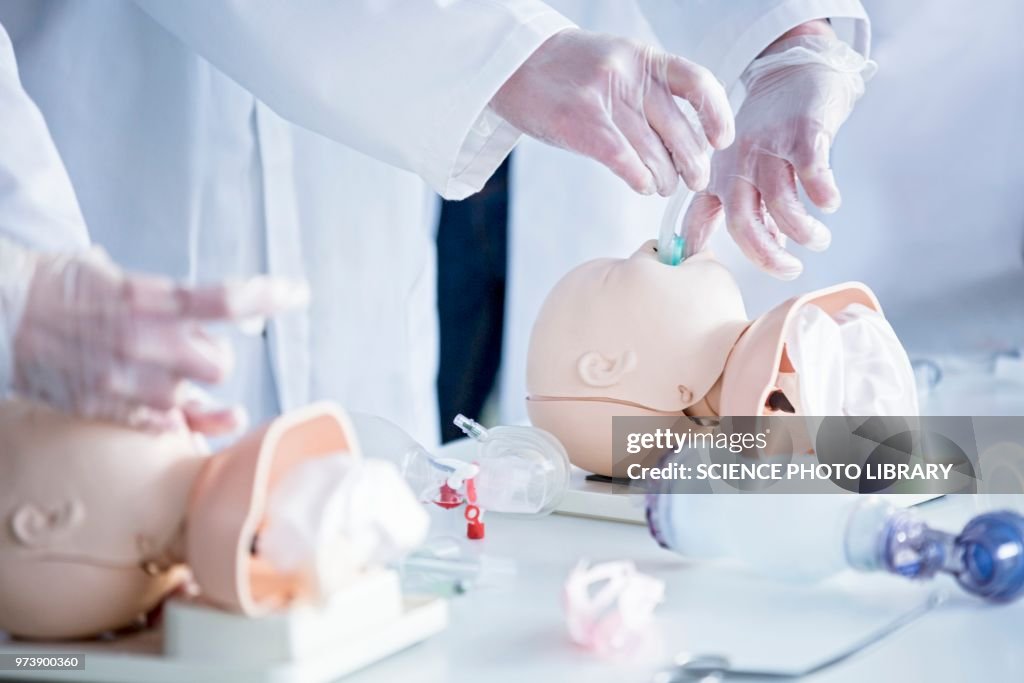 Doctors practising infant intubation