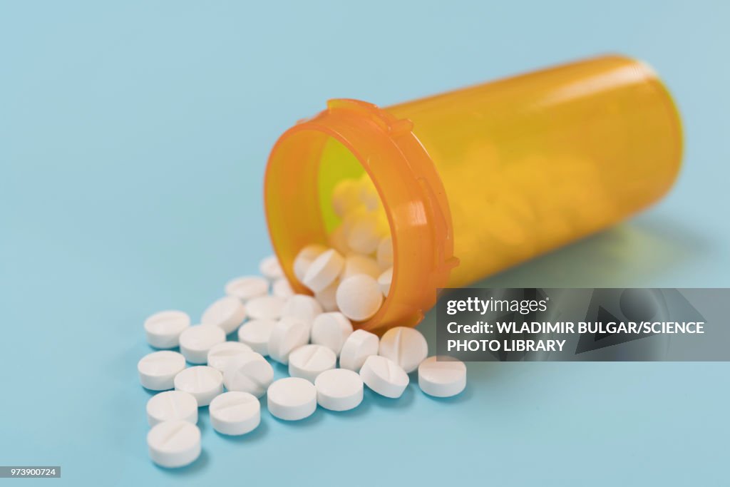 White pills spilling from bottle