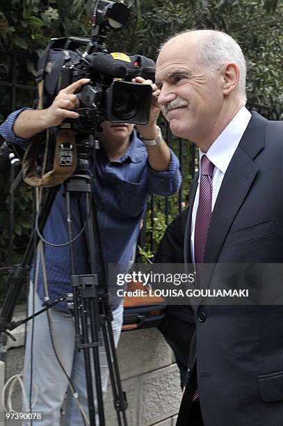 Greek Prime Minister George Papandreou walks to his office after his meeting with the Greek president Carolos Papaoulias in Athens on March 3, 2010....