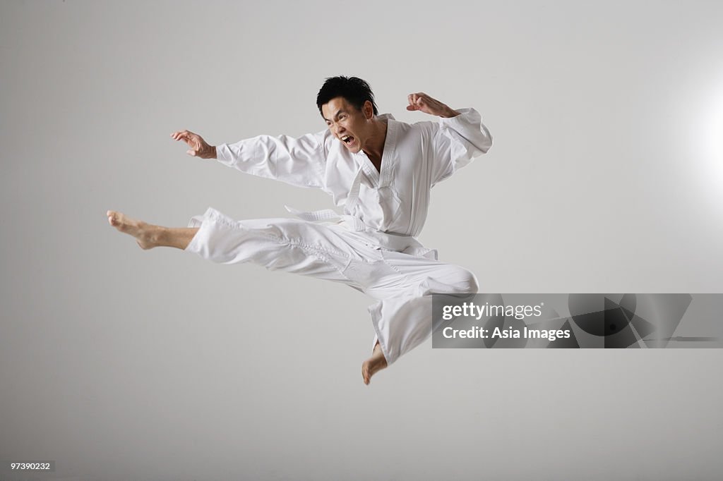 Man doing a flying kick, martial arts