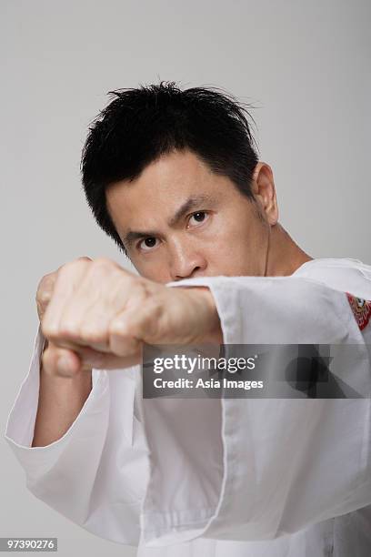 head shot of chinese man punching, martial arts - gidräkt bildbanksfoton och bilder
