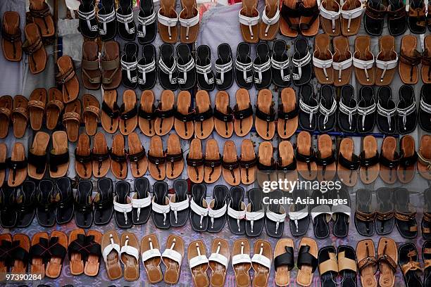 many leather sandals on display at market. - baju melayu stock pictures, royalty-free photos & images