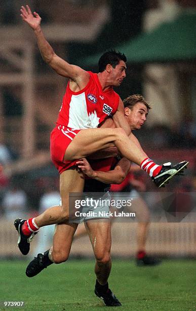 John Stevens of Sydney Swans kicks under pressure during the AFL trial match between the Sydney Swans and the Essendon Bombers at North Sydney Oval,...