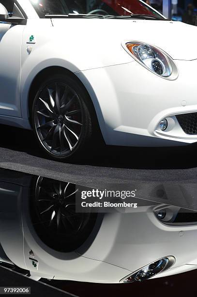 An Alfa Romeo Mito automobile is seen reflected on the second press day of the Geneva International Motor Show in Geneva, Switzerland, on Wednesday,...