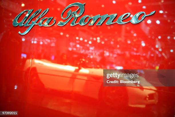 An Alfa Romeo Spider automobile is seen reflected on the second press day of the Geneva International Motor Show in Geneva, Switzerland, on...