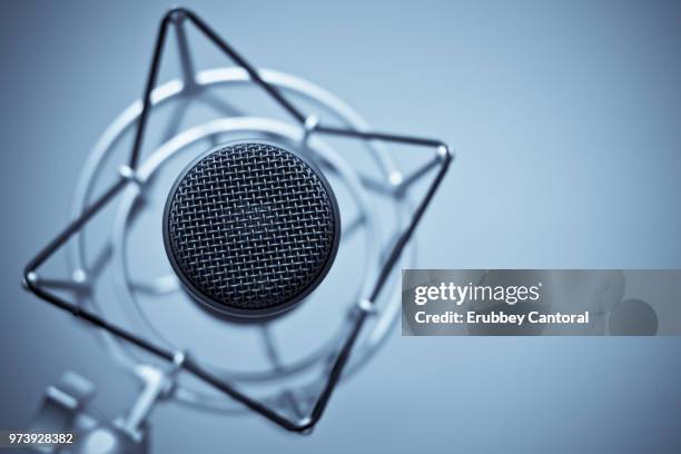 studio shot of condenser microphone on blue background - condenser microphone stock pictures, royalty-free photos & images