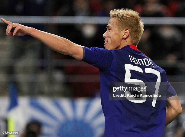Keisuke Honda of Japan celebrates after scoring his team's second goal during the AFC Asian Cup Qatar 2011 Group A qualifier football match between...