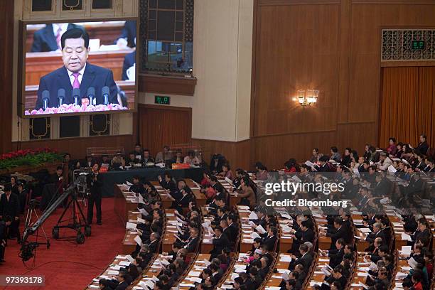 Jia Qinglin, chairman of the Chinese People's Political Consultative Conference , is displayed on a monitor as he speaks during the CPPCC at the...