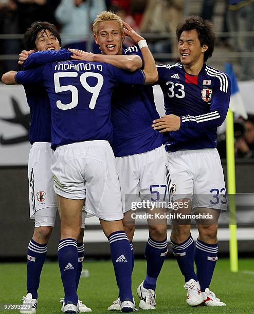 Keisuke Honda of Japan celebrates with his team mates after scoring his team's second goal during the AFC Asian Cup Qatar 2011 Group A qualifier...