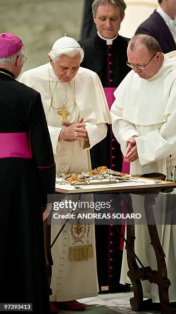 Pope Benedict XVI blesses a gift in Aula Paolo VI at the Vatican during his weekly general audience on March 3, 2010 . Pope Benedict XVI will visit...