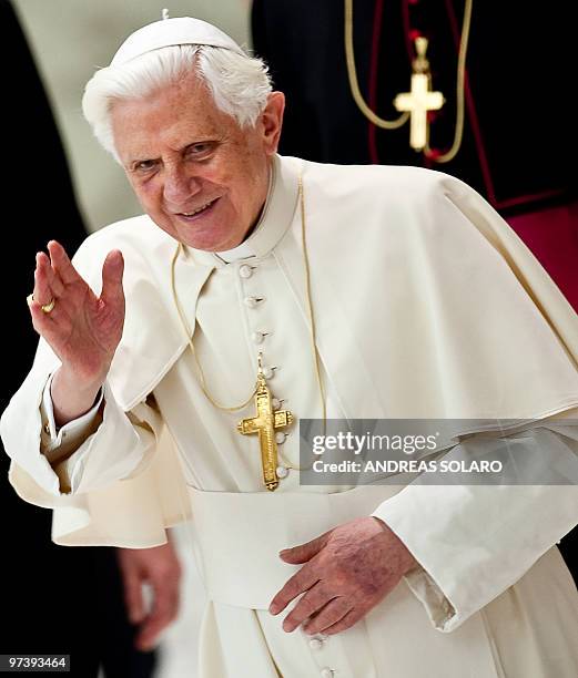 Pope Benedict XVI waves to the faithful gathered in Aula Paolo VI at the Vatican as he leaves his weekly general audience on March 3, 2010 . Pope...