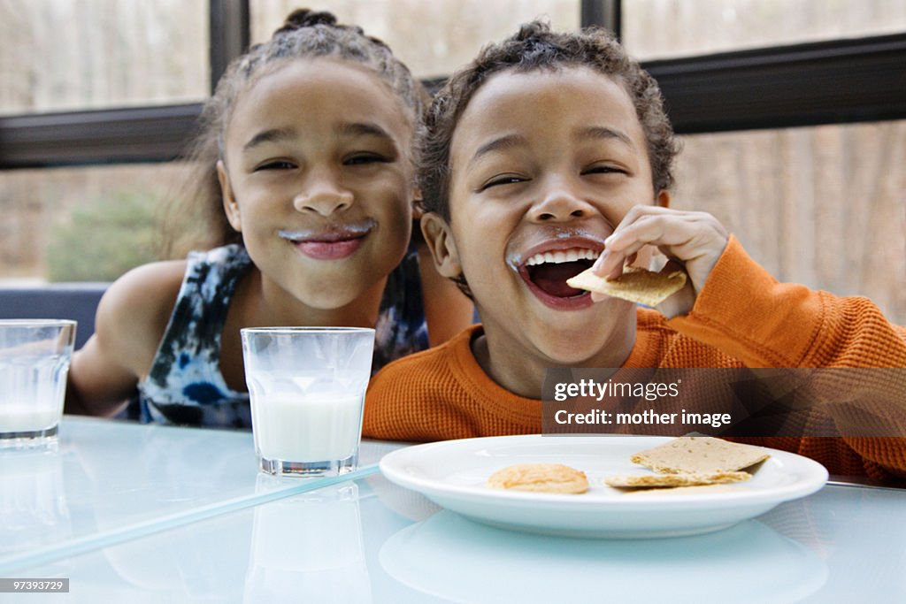 Pre teen african american siblings snacking