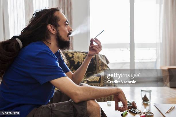 men smoking marijuana joint - cigarette bud stock pictures, royalty-free photos & images