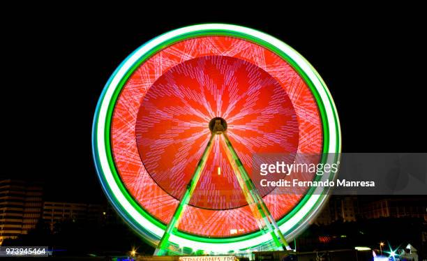 illuminated ferris wheel at night, valencia, spain - manresa stock pictures, royalty-free photos & images