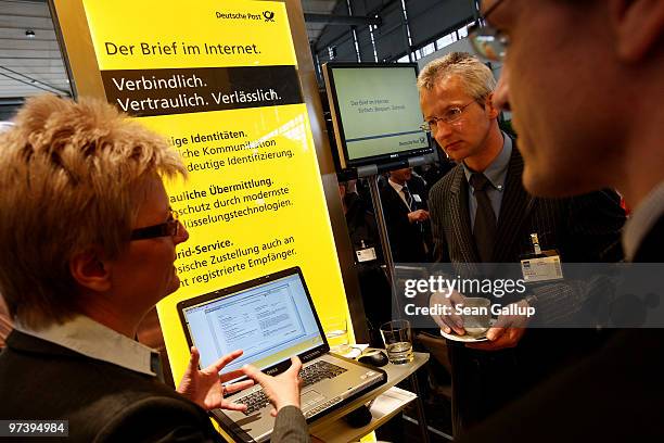 Fair hostess explains the Internet mail system of German postal service provider Deutsche Post at the CeBIT Technology Fair on March 3, 2010 in...