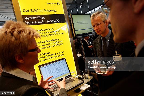 Fair hostess explains the Internet mail system of German postal service provider Deutsche Post at the CeBIT Technology Fair on March 3, 2010 in...
