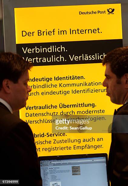 Fair hostess explains the Internet mail system of German postal service provider Deutsche Post at the CeBIT Technology Fair on March 3, 2010 in...