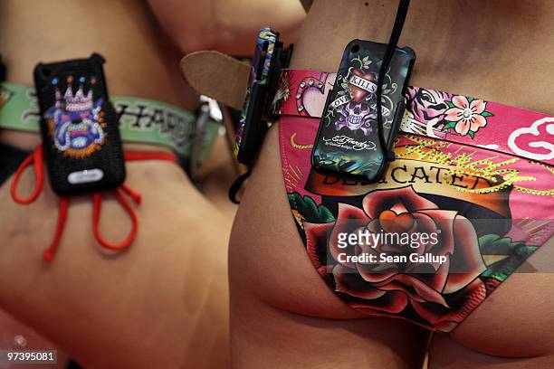 Mobile phone covers by French designer Christian Audigier under his Ed Hardy label adorn the bodies of fair hostesses at the CeBIT Technology Fair on...
