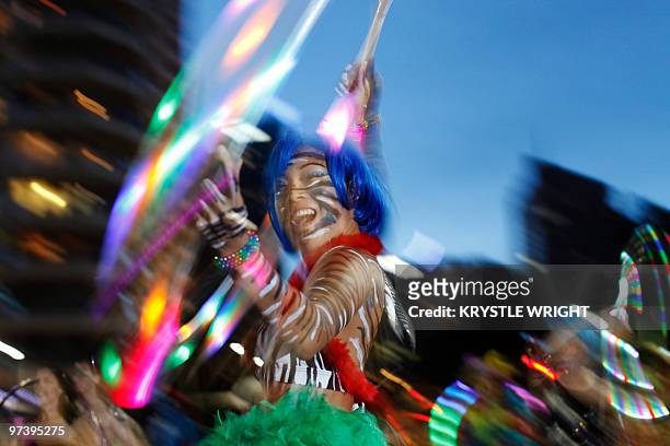 Parade goers dance during the 32nd annual Gay and Lesbian Mardi Gras parade through Sydney on February 27, 2010. This year's parade showcased the...
