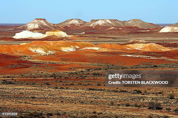 The ochre-hued formation known as The Breakaways rises above the desert plain near the opal mining town of Coober Pedy, 05 July 2005. The moon-like...