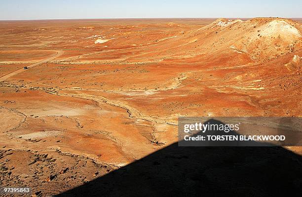 The ochre-hued formation known as The Breakaways rises above the desert plain near the opal mining town of Coober Pedy, 05 July 2005. The moon-like...