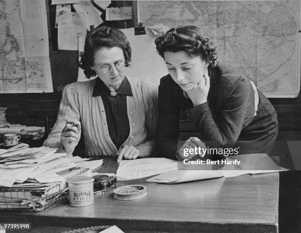 Journalists Margaret Peters and Janet Grey in the feature writer's room at the offices of the Daily Mirror newspaper in London, April 1942. Original...