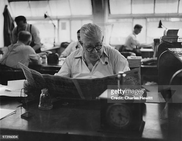 Sub-editor Tom Innes in the Fetter Lane offices of the Daily Mirror newspaper, London, July 1953. Original publication; Picture Post - 6739 - The...