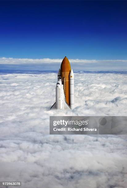 a rocket sticking out of a blanket of cloud. - shuttle stock pictures, royalty-free photos & images
