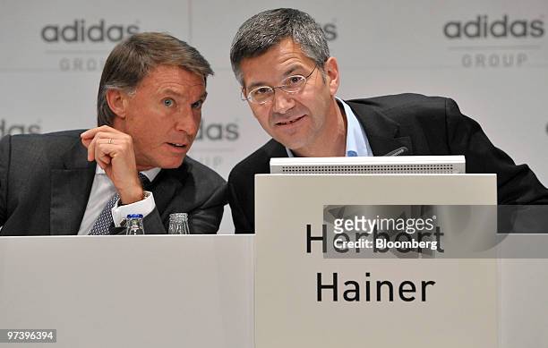 Robin J. Stalker, chief financial officer of Adidas AG, left, speaks with Herbert Hainer, chief executive officer of Adidas AG, during the company's...