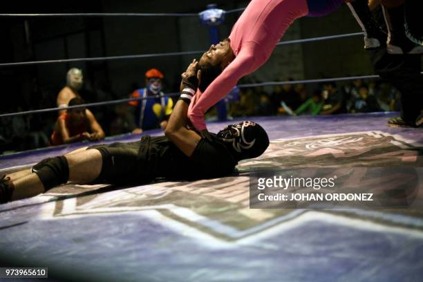 Guatemalan wrestler Relampago Negro takes control of Medico Fuerza Revelde during the wrestling event "Luchando por Guatemala"for the victims of the...