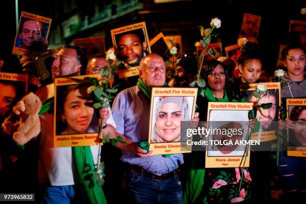 Families and friends who lost loved ones in the Grenfell Tower fire hold portraits of victims as they march to Grenfell Tower in west London at...