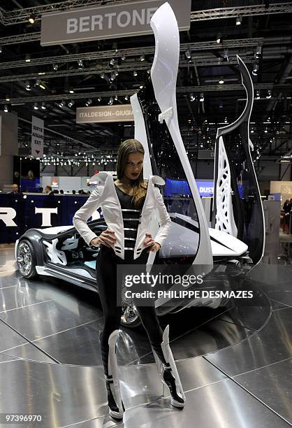 Model poses beside a car by Italian carmaker Bertone on March 3, 2010 during the third press day at the 80th Geneva International Motor Show at...