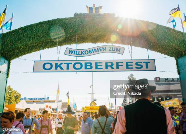 main entrance gate to oktoberfest fairground in munich - entrance sign stock pictures, royalty-free photos & images
