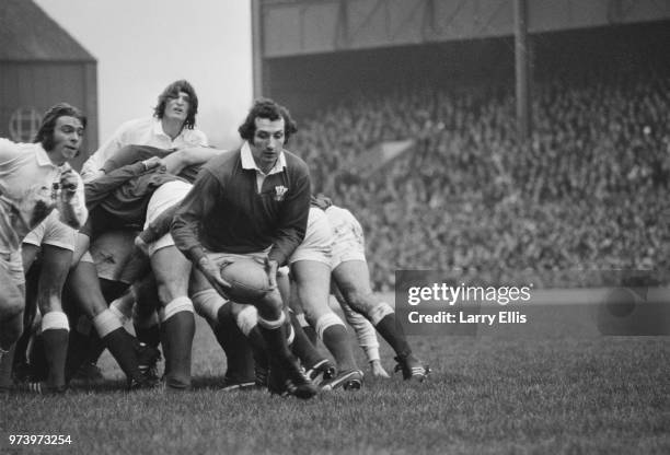 Welsh rugby player and scrum half for the Wales national rugby union team, Gareth Edwards pictured with the ball during the 1972 Five Nations...