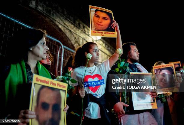Families and friends who lost loved ones in the Grenfell Tower fire hold portraits of victims as they march to Grenfell Tower in west London at...