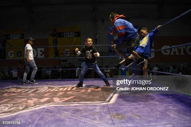 Children play on the ring, before the benefit wrestling event "Luchando por Guatemala" for the victims of the Fuego volcano eruption, at the Arena...