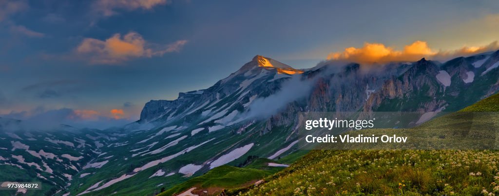 Adygea landscape with the mountain and orange clouds