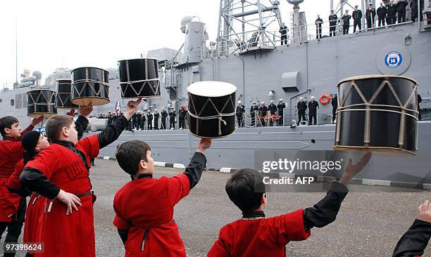 Georgian boys in traditional clothing perform with drums for the crew of the frigate USS John L. Hall in Georgia's Black Sea port city of Batumi on...