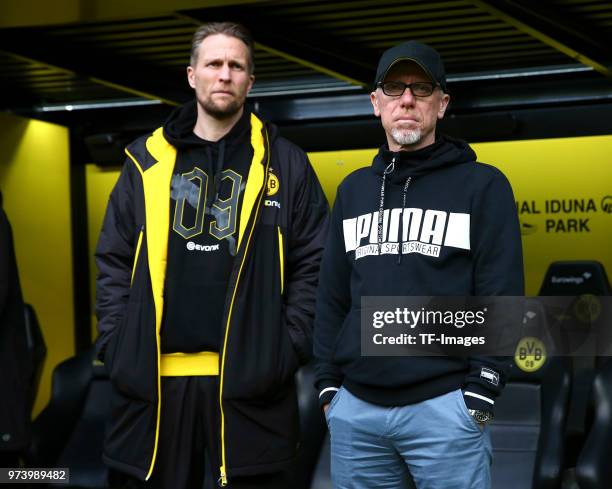 Assistant coach Alexander Bade of Dortmund and Head coach Peter Stoger of Dortmund look on prior to the Bundesliga match between Borussia Dortmund...