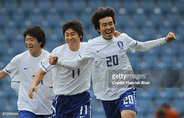 Lee Dong-Gook of Korea celebrates with team mates after scoring his team's first goal during the International Friendly match between Ivory Coast and...