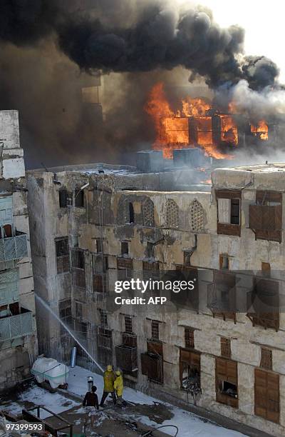 Firefighters douse the flames in one of the buildings which caught fire in the historic quarter of the Saudi Red Sea port city of Jeddah on March 3,...